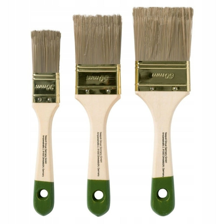 A set of flat natural bristle paintbrushes with green wooden handles and metal ferrules